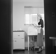 Woman Washing Dishes, Interior of Completed House, New Deal Cooperative Community, Greenbelt, Maryland, USA, Arthur Rothstein, Farm Security Administration, November 1936