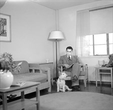 Man and Dog Sitting in Livingroom, Interior of Completed House, New Deal Cooperative Community, Greenbelt, Maryland, USA, Arthur Rothstein, Farm Security Administration, November 1936