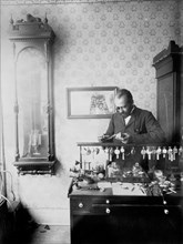 Mr. Dodson, Jeweler, Standing Behind Display of Watches, Examining a Pocket Watch, Nashville, Tennessee, USA, W.E.B. DuBois Collection, 1899