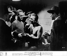 Actor Kirk Douglas (center), on-set of the Film, "Champion", United Artists, 1949