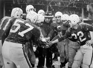 Football Team in Huddle, on-set of the Film, "The Guy who Came Back", 20th Century Fox, 1951