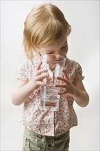 Blonde Toddler Looking into Glass of Water