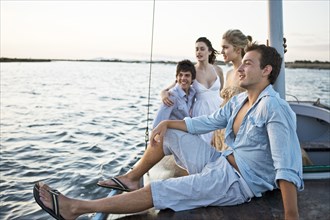 Two Young Couples Relaxing on Sailboat