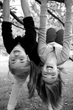Two Girls Hanging Upside Down