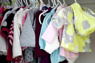 Baby Clothes Hanging in Closet