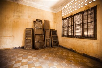 Window Shutters and Wood Panels Against Wall in Empty Room, S21 Prison, Phnom Penh, Cambodia