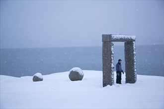Young Man in Sculpture Doorway in Snow, Norway