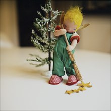 Christmas Elf Sweeping by Tree