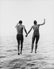 Couple Jumping into Water, Rear View