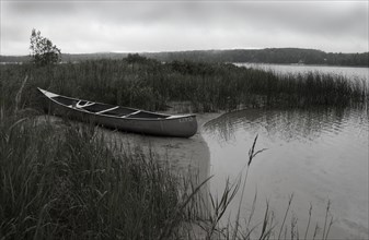 Beached Canoe on Small Lake