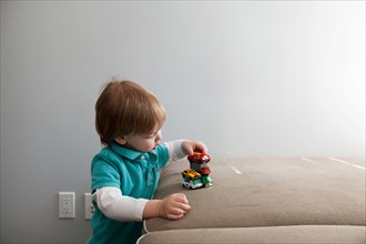 Little Boy Playing with Toy Cars
