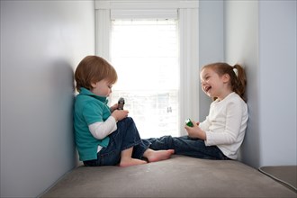 Young Boy and Girl Playing With Toy Cars
