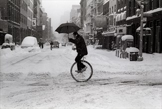 Unicyclist with Umbrella in Winter