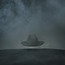 Wide-Brimmed Hat Floating in Fog