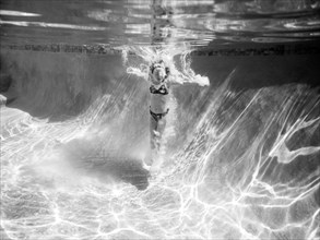 Girl Underwater after Jumping in Pool