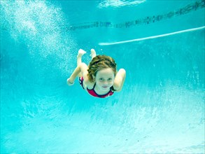 Girl Swimming Underwater in Pool, Eye Contact
