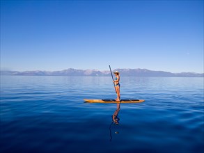 Woman Standing on Paddleboard Holding Paddle 2
