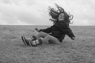 Young Girl Having Fun and Falling on Ground