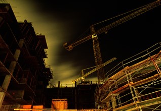 Construction Site and Crane at Night, Low Angle View