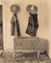 Cowboy Chaps and Hats Hanging on Wall