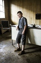 Young Boy in Abandoned Office, Portrait