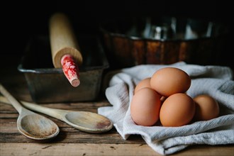 Brown Eggs with Wood Spoon, Baking Tins and Roller