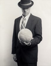 Man in Suit with Globe