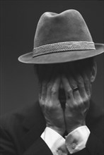 Distressed Man in Hat
