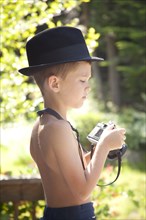 Young Boy Wearing Fedora Hat and Holding Camera