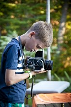 Profile of Young Boy with Camera