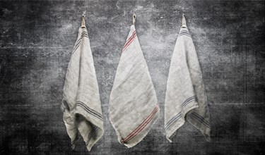 3 Linen Towels Hanging on Slate Gray Stone Wall