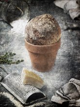 Cheese and Grater with Bread in Terra Cotta Pot