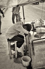 Vendor Leaning Against Cart in Heat, New Delhi, India
