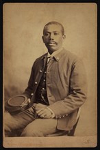 Buffalo Soldier, 25th Infantry, Seated Portrait in Uniform Holding Hat, by Orlando Scott Goff, William A. Gladstone Collection of African American Photographs, 1880's