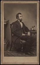 Full-Length Seated Portrait of Abraham Lincoln, his first sitting for a Portrait, Washington DC, USA, Photograph by Alexander Gardner, 1861