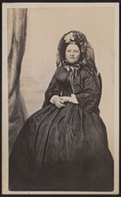 Full-Length Seated Portrait Mary Todd Lincoln in Mourning Attire after the death of her son, Willie in 1862, Photograph by Joseph Ward, possibly 1863, when she entered a period of half-mourning by evi...