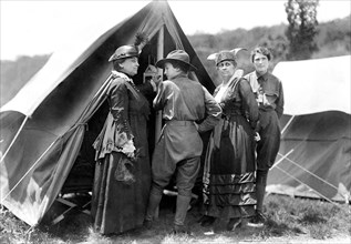 Mary Dimmick Harrison, wife of President Benjamin Harrison and her daughter Elizabeth Harrison Walker with Mrs. Green and probably her daughter, Helen standing at tent of Emergency Services Corps camp...