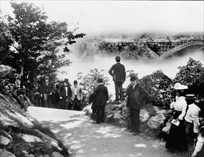 U.S. President William McKinley Walking on Road with others with Niagara Falls in distant Background, Goat Island, New York, USA, Photograph by O.E. Dunlap, September 6, 1901