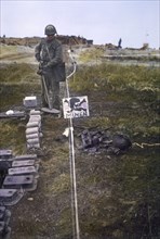 U.S. Soldier using Mine Detector to Identify Mines Laid in Field, Normandy, France, June 1944