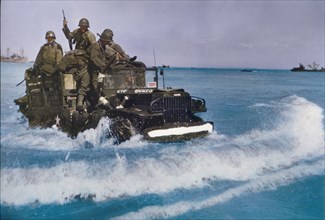 U.S. Military Truck with Soldiers driving through water toward shore during Invasion of Normandy, France, June 1944