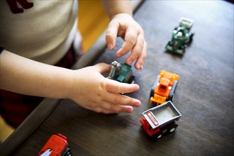 Young Boy Playing with Toy Trucks