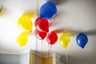Colorful Helium-Filled Balloons on Ceiling,
