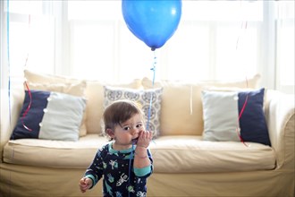Infant Boy Holding Blue Balloon