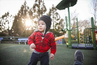 Young Boy at Playground with Sun Flare in Background