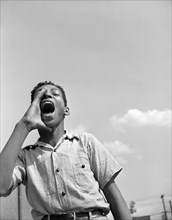 Teen Boy Shouting to Friends at Playground, Frederick Douglass Housing Project, Anacostia Neighborhood, Washington DC, USA, Photograph by Gordon Parks, June 1942