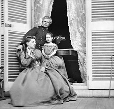 Gen. Edward O.C. Ord, wife and child at the residence of Jefferson Davis, In doorway is  table on which the Surrender of Gen. Robert E. Lee was Signed, Richmond, Virginia, USA, April 1865