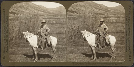 President Theodore Roosevelt on Horseback, Mountains in background, The bronzed President, after three weeks Exposure to Wind and Storm in Mountains of Colorado, USA, Stereo Card, H.C. White Co., June...