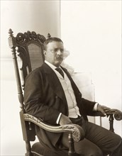 Theodore Roosevelt (1858-1919), 26th President of the United States 1901-09, Three-quarter Length Seated Portrait on Porch, Photograph by Conrad M. Gilbert, April 1904