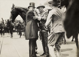 Theodore Roosevelt and Col. Alexander O. Brodie, in Uniform, Greeting each other, Surrounded by Horses, Photograph by Paul Thompson, June 1910