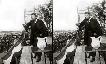 U.S. President Theodore Roosevelt on a platform speaking to Crowd, large white pitcher in foreground, Concord, New Hampshire, Stereo Card, January 5, 1907